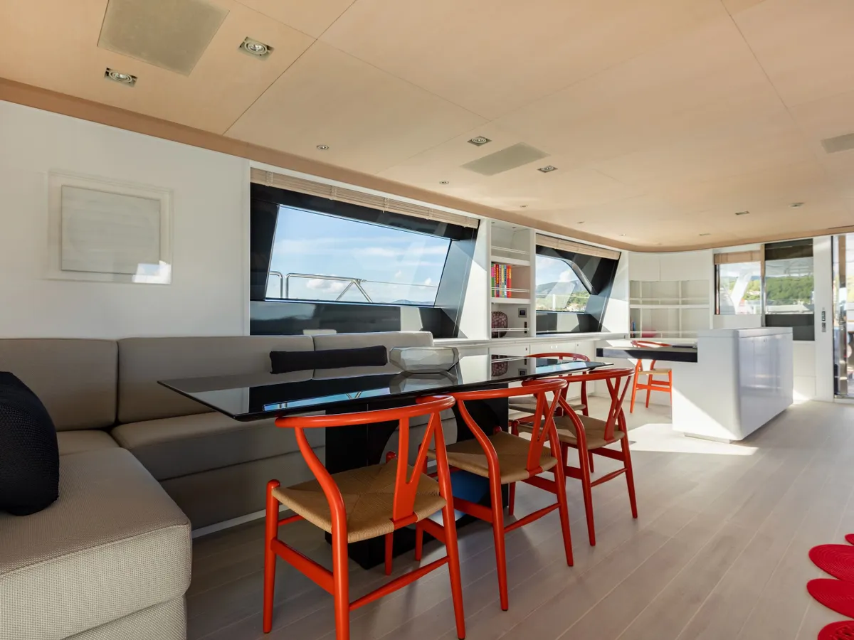The saloon dining counter with orange chairs and wide windows over the water