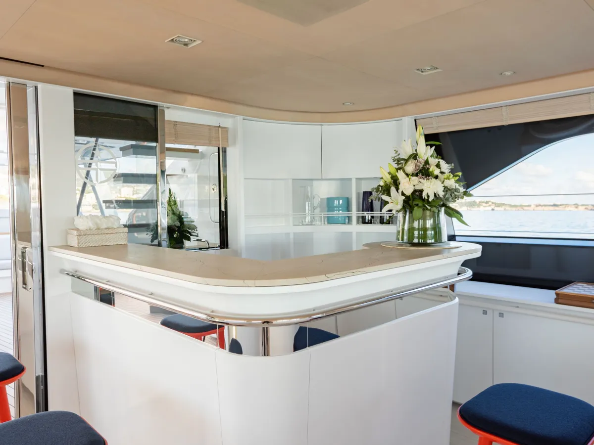 The curved saloon bar counter with fresh flowers and a window onto the water