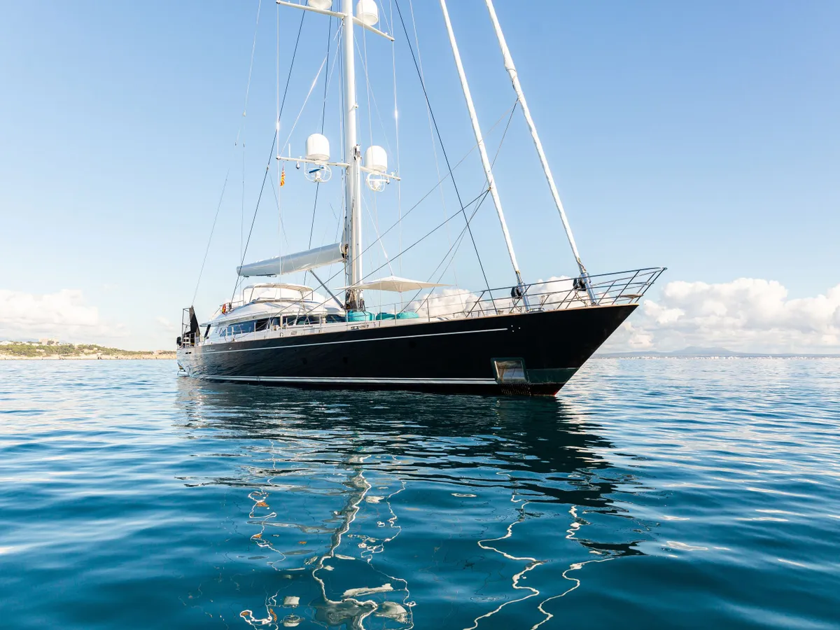 The long bow of Serendipity I seen from the water with blue sky above