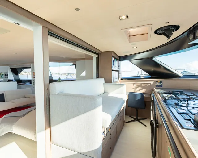 Modern yacht galley with stainless steel appliances and light wood finishes